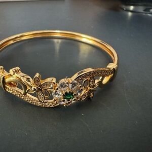 Gold Floral Bangle Bracelet with Sparkling Stones & Emerald Center